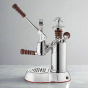 La Pavoni Esperto Abile Coffee Machine in polished chrome finish with wooden handles, featuring a professional-grade lever mechanism, pressure gauge, and drip tray on a sturdy base with elegant vintage-inspired design elements